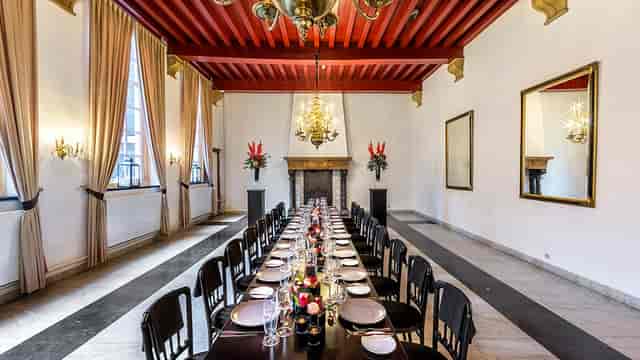Schutterszaal in West-Indisch Huis with red timber ceiling for executive dinners and board meetings.