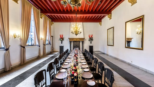 Schutterszaal in West-Indisch Huis with red timber ceiling for executive dinners and board meetings.