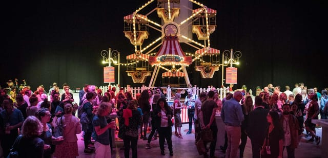 Indoor carnival-themed event at Blackbox Amsterdam featuring a branded Ferris wheel for networking.