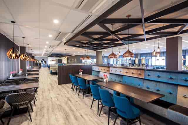 Modern restaurant venue in Amsterdam with banquette seating for networking and workshops.