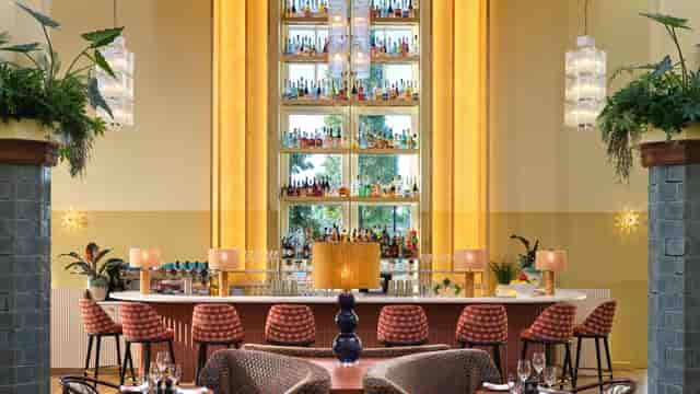 The Hoxton Amsterdam Drawing Room with architectural bar for luxury corporate networking events.
