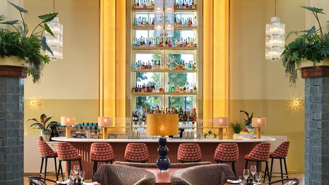 The Hoxton Amsterdam Drawing Room with architectural bar for luxury corporate networking events.