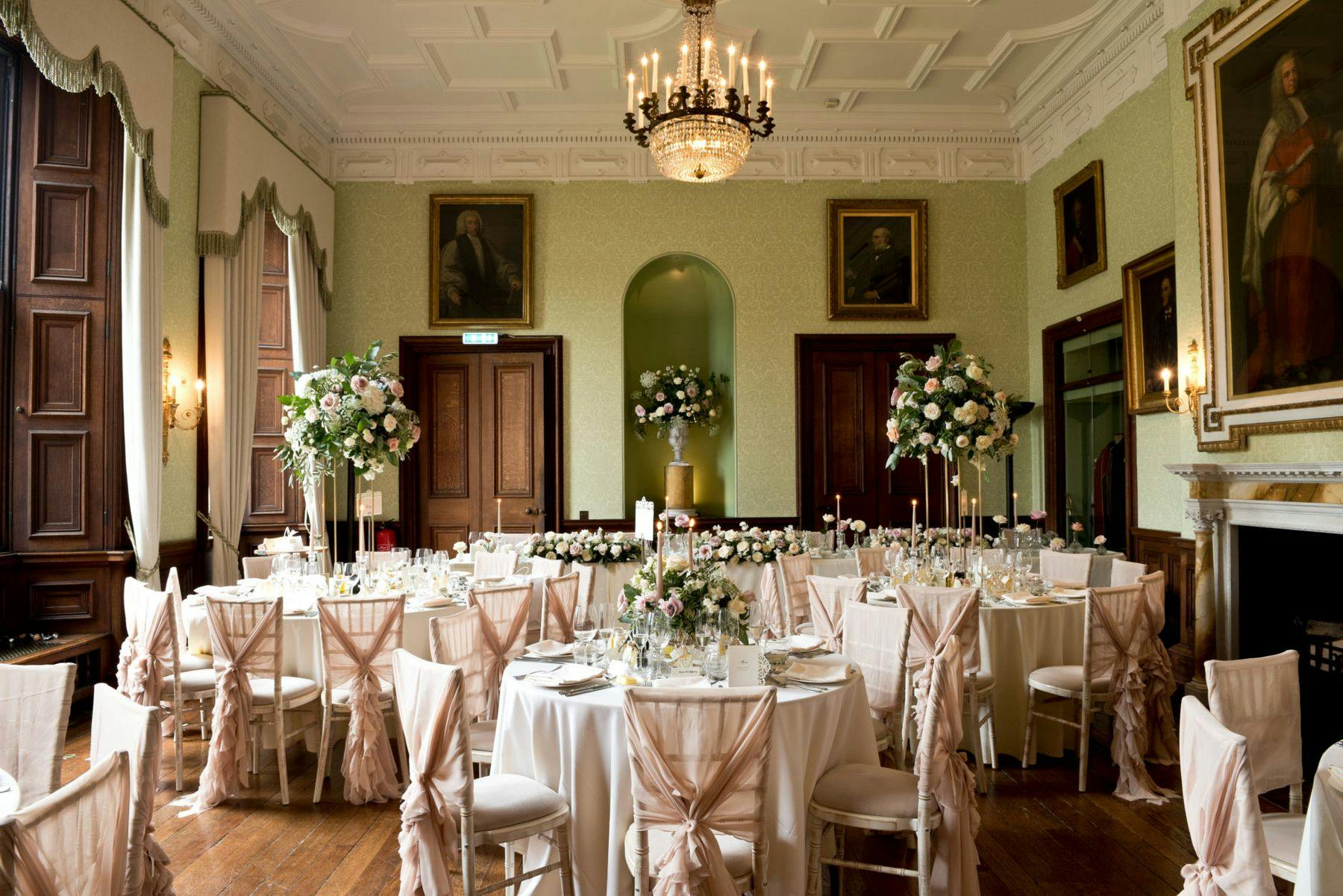 Elegant wedding marquee at Sandon Hall with pink accents and floral centerpieces.