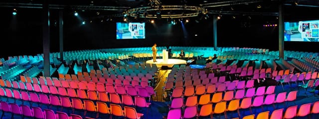 Circular stage with truss lighting at Taets Art and Event Park for keynote and theater events.
