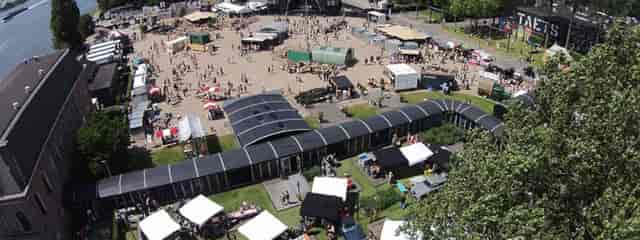 Hal 1 Glass Pavilion outdoor festival layout with modular structures and food trucks.