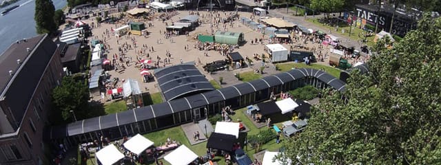 Hal 1 Glass Pavilion outdoor festival layout with modular structures and food trucks.
