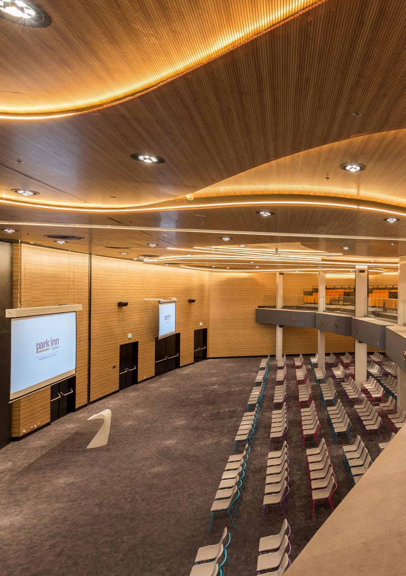 Pearl Ballroom, Amsterdam: Tiered auditorium with modern wood paneling for corporate presentations.