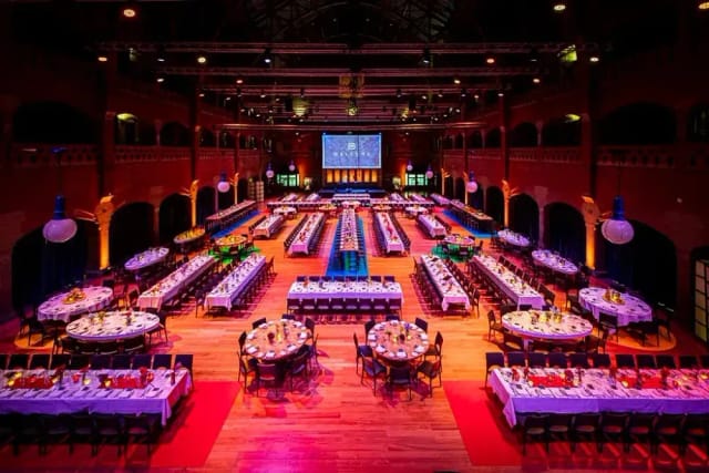 Gala setup at Pearl Ballroom Amsterdam: historic venue with banquet tables and stage.