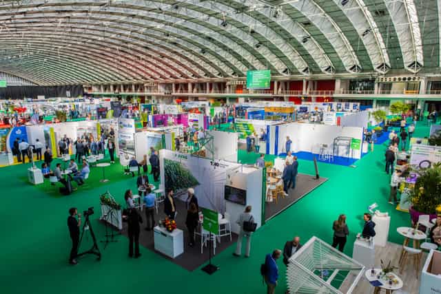 GreenTech exhibition hall, spacious modular booths, networking event, trade show venue.