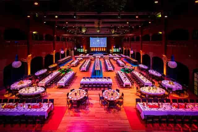 Industrial banquet hall with mixed seating, perfect for gala dinners and corporate events.