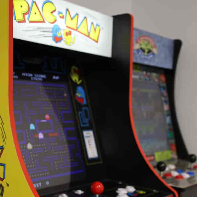 Classic arcade cabinet in Paragon Creative Studios boardroom for corporate event networking.