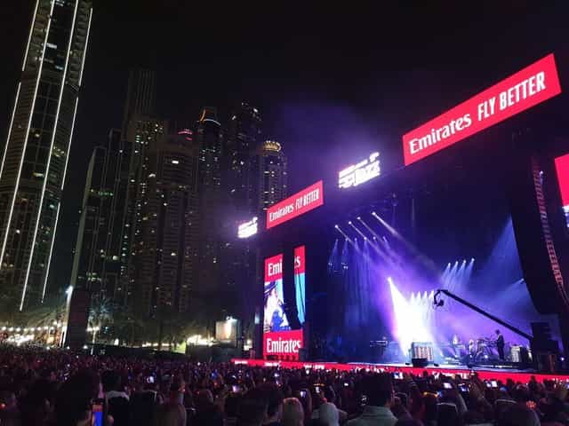 Outdoor concert at Dubai Internet City Amphitheatre, event venue with urban backdrop.