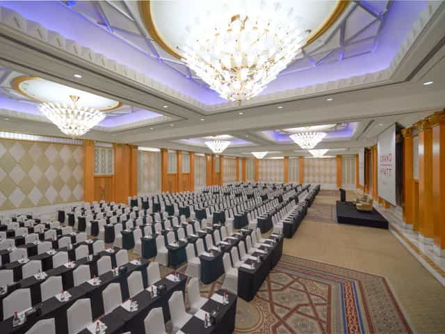 Schoolroom-style ballroom at The Event Centre with chandelier lighting for corporate conferences.