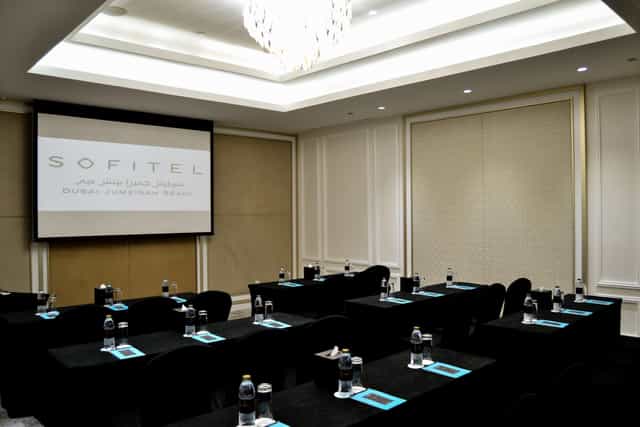 Classroom-style boardroom at Sofitel Dubai Jumeirah Beach for professional corporate meetings.
