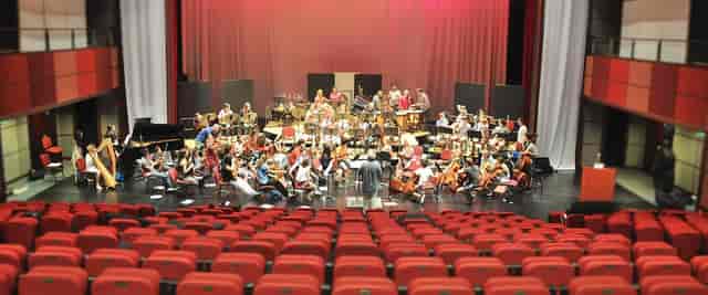 Symphonic orchestra stage in auditorium for professional concert performance and event venue.