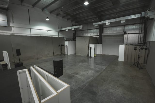 Industrial warehouse event space with exposed concrete, perfect for venue hire and event production.