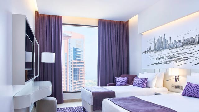 Modern hotel twin room in Mercure Dubai Barsha Heights for business travel and conference booking.
