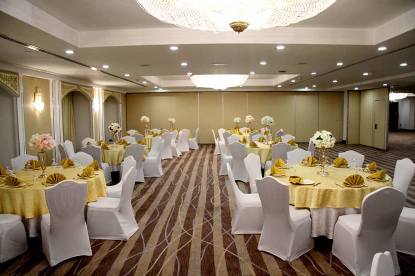 Banquet hall at Grand Excelsior Bur Dubai with gold tables for corporate events and weddings.