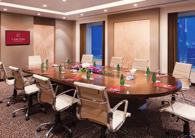 Boardroom meeting room at Carlton Downtown Hotel with city views for corporate business events.