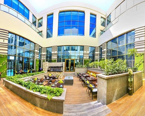 Outdoor courtyard venue for corporate networking and breakout sessions at Metropolitan Hotel Dubai.