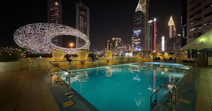 Rooftop pool lounge in Dubai with skyline views for cocktail receptions and networking events.
