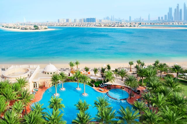 Luxury Kempinski Palm Jumeirah beach resort with pool for corporate retreats and executive off-sites.