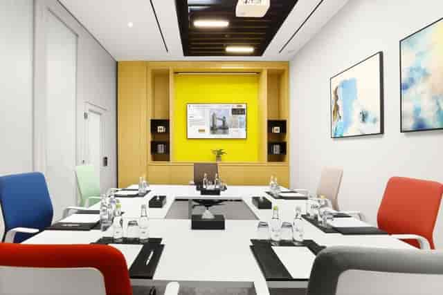 Modern boardroom at Millennium Al Barsha with ergonomic seating for professional business meetings.