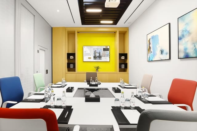 Modern boardroom at Millennium Al Barsha with ergonomic seating for professional business meetings.