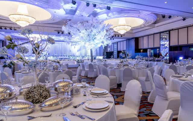 Winter-themed ballroom gala with floral centerpieces for formal corporate events and weddings.