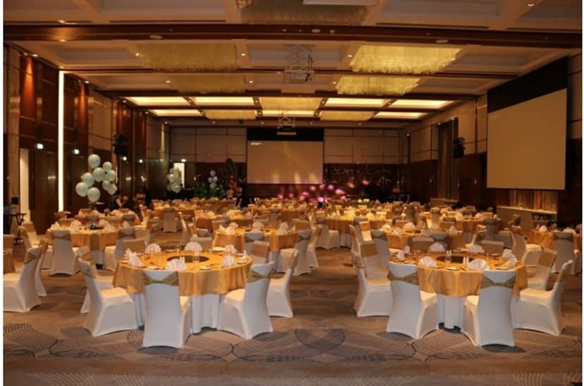 Grand Ballroom with gold banquet tables for corporate gala or formal event.