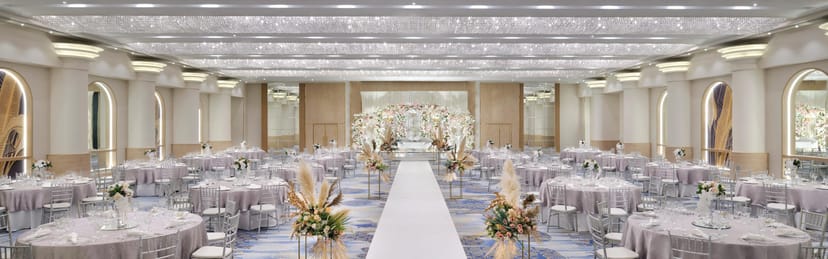 Al Habari ballroom, Crowne Plaza Dubai: Elegant wedding venue with floral decor and white aisle.