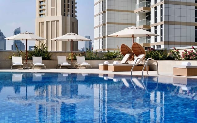 Urban poolside reception area at Mövenpick Dubai for corporate events and networking.
