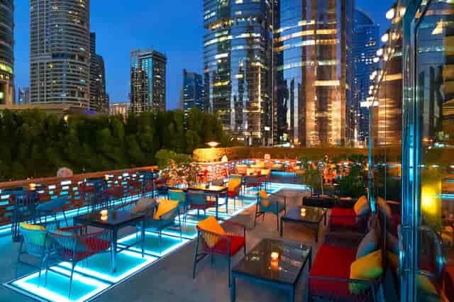 Rooftop cocktail reception at Gemino, Dubai featuring LED flooring and urban skyline.