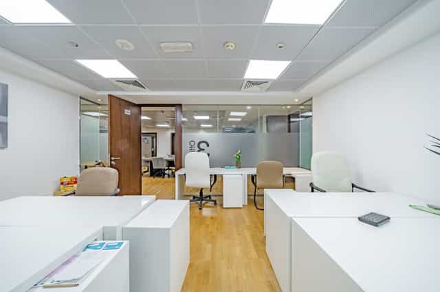 Modular private office space with minimalist desks for individual work or small meetings.
