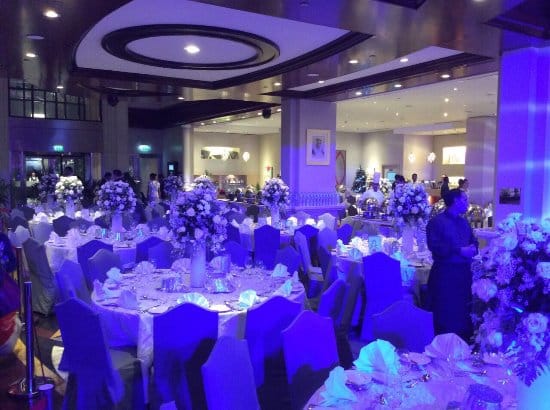 Oud Metha Ballroom gala banquet setup with floral centerpieces, ideal for corporate events.