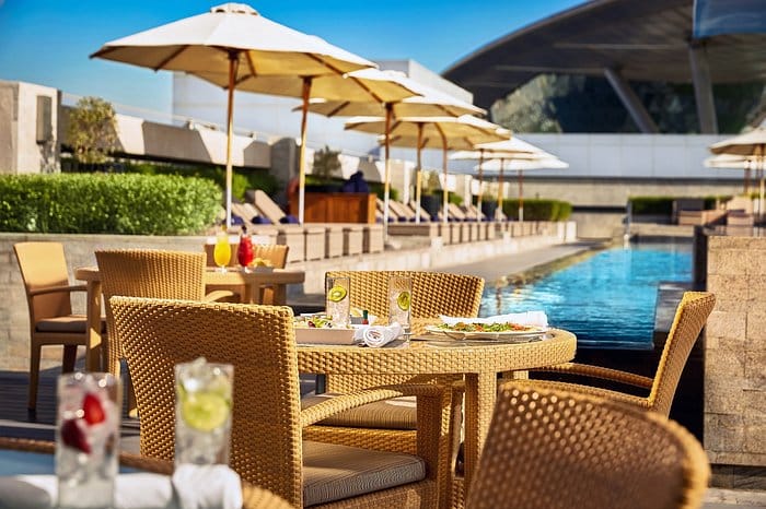 Meydan Hotel rooftop infinity pool for upscale networking events and corporate breakout sessions.