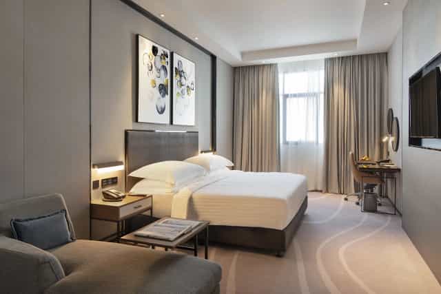 Modern hotel suite with workspace for corporate travel and business room block events.
