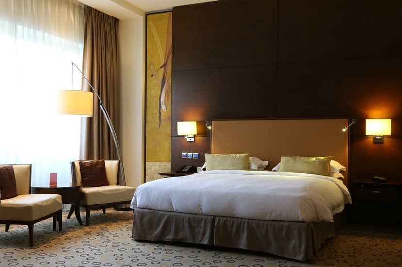 Luxury Asiana Hotel suite with seating area for executive meetings and business travel.