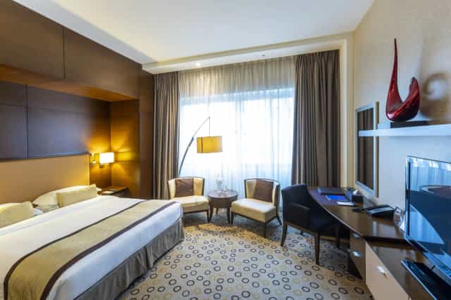 Asiana Hotel upscale suite with ergonomic workspace for business travel and corporate events.