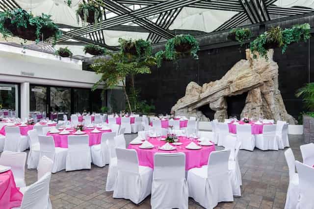 Wyndham Dubai Deira banquet hall with fuchsia decor for corporate events and wedding receptions.