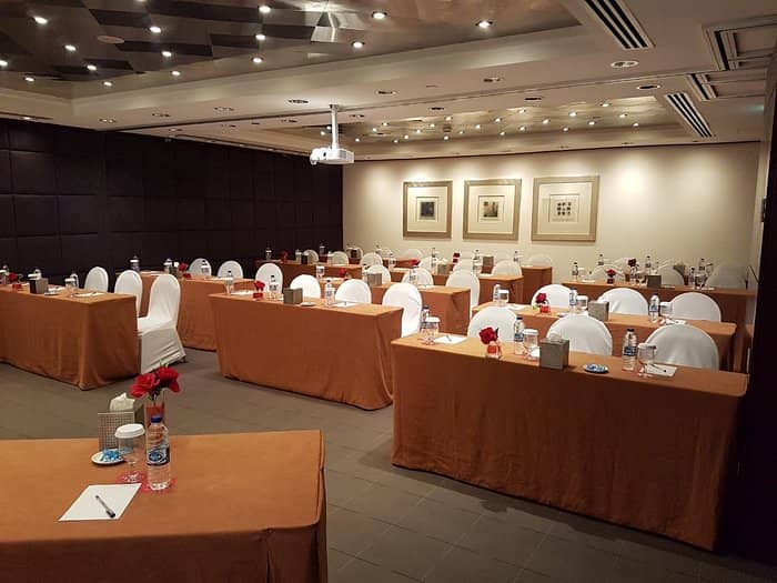Wyndham Dubai Deira ballroom with dark wood paneling, ideal for professional meetings and events.