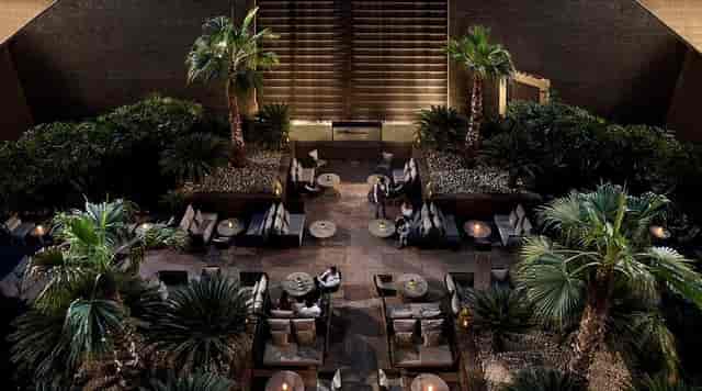 Upscale networking reception at The Summer Garden business center with lush greenery.