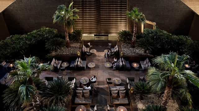 Upscale networking reception at The Summer Garden business center with lush greenery.