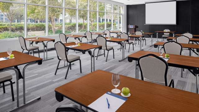 Classroom-style meeting room with natural light, ideal for corporate workshops and training events.