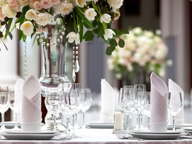 Elegant Dalma Ballroom table setting with floral centerpiece for gala or wedding reception.