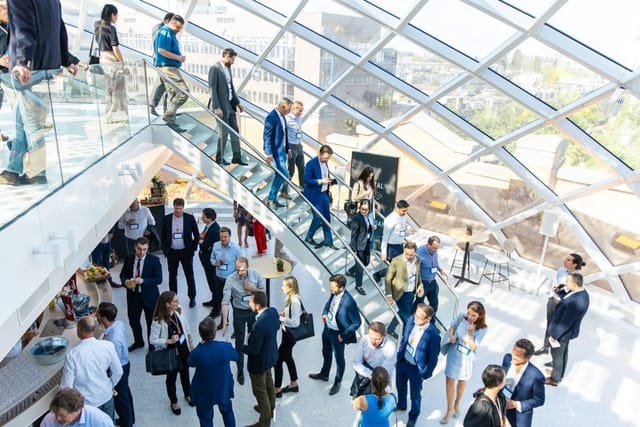 Vibrant networking event in modern conference space, Capital C Amsterdam, showcasing collaboration.