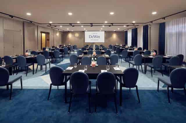 Modern conference room with round tables for corporate meetings at Kimpton De Witt.