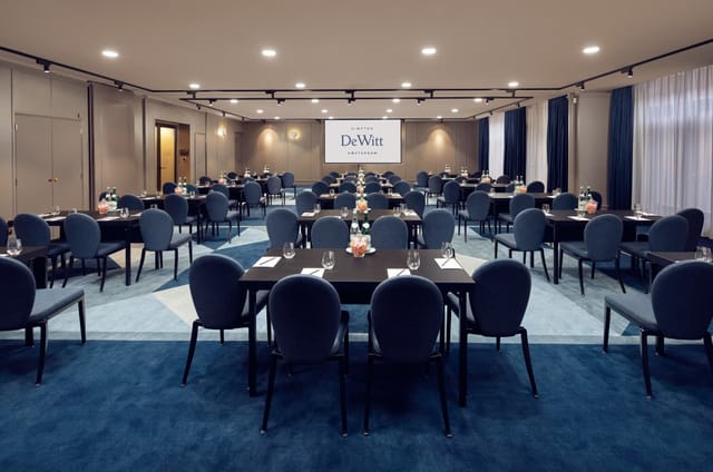 Modern conference room with round tables for corporate meetings at Kimpton De Witt.
