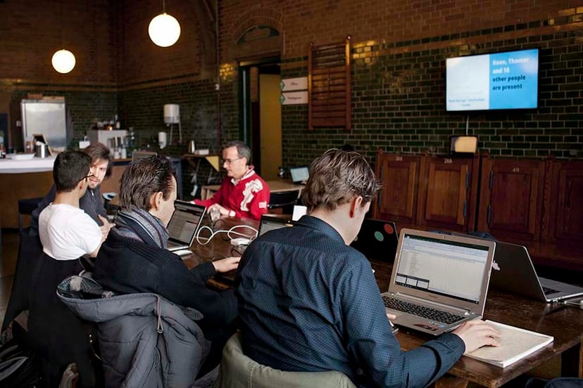 Collaborative meeting space in modern industrial setting with team brainstorming.