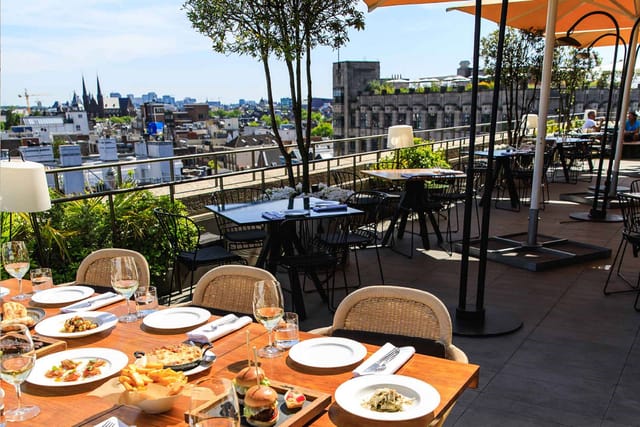 Rooftop terrace in NIM Amsterdam for upscale events with elegant table settings.